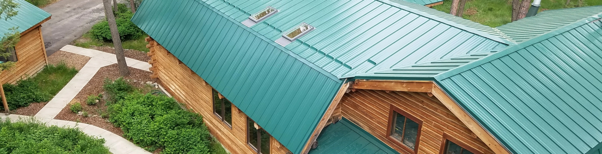 New Green standing seam roof on log home